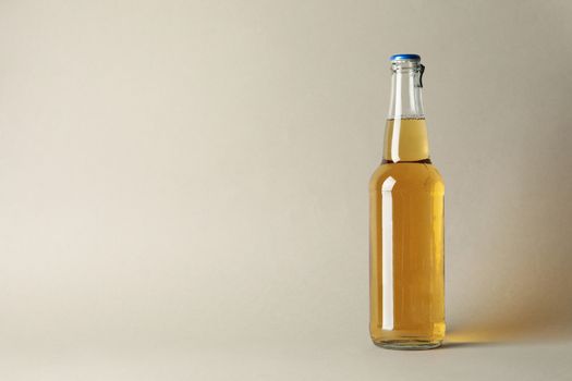 Bottle of beer on gray background, space for text