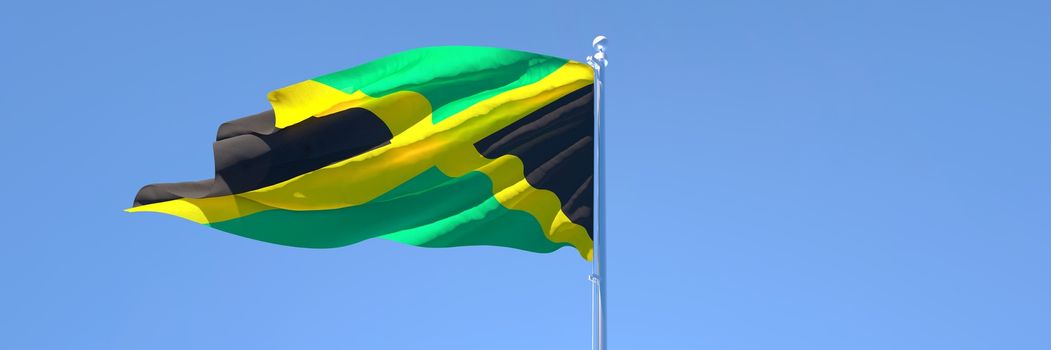 3D rendering of the national flag of Jamaica waving in the wind against a blue sky