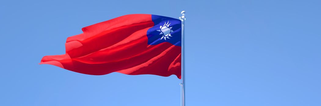 3D rendering of the national flag of Taiwan waving in the wind against a blue sky