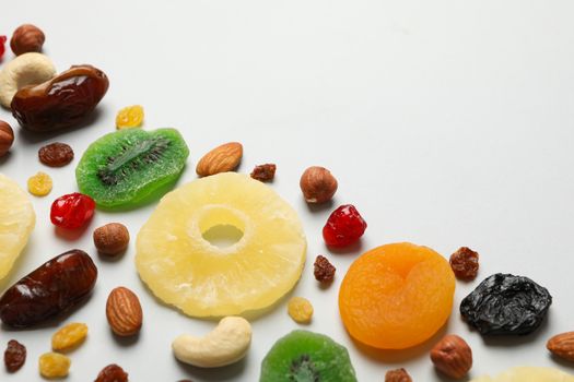 Nuts and dried fruits on gray background, space for text