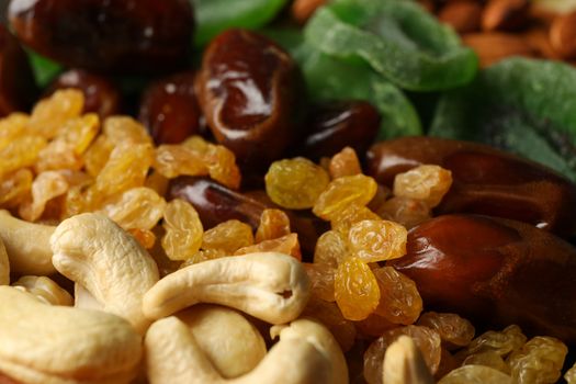 Different dried fruits and nuts on whole background