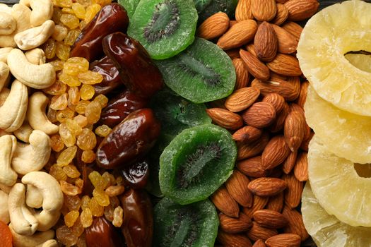 Different dried fruits and nuts on whole background