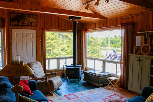 Lights turn off and turn on in living room with the stairs in the cottage.