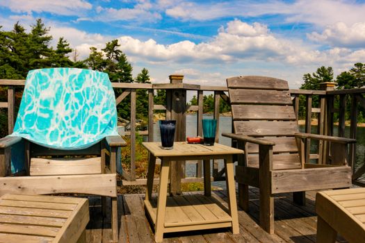 Adirondack chairs at shore of Lake of Two Rivers, Ontario, Canada.