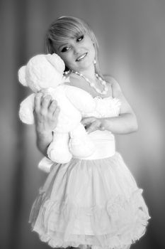 young blonde girl with a soft toy