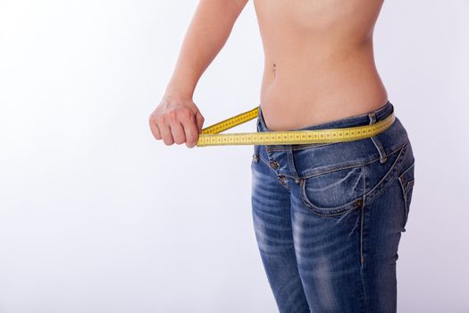 woman in jeans with a tape measure