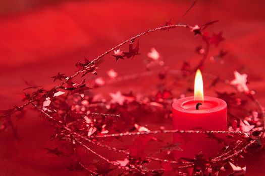 Red Christmas decoration with candlelight on fabric