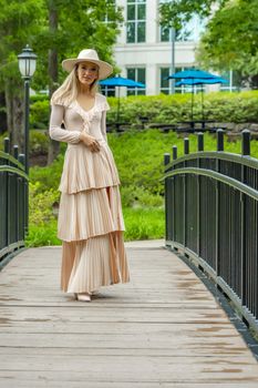 A gorgeous blonde model poses outdoors in her fall clothes