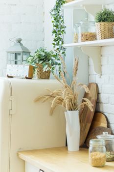 Kitchen at home with white modern interior and cream colour refrigerator