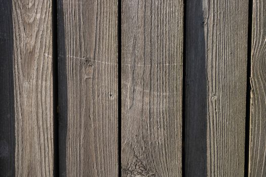 Wooden fence on a Sunny day. Grey wood background textures.