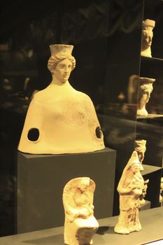 Alicante, Spain- October 8, 2020: Cauldrons shaped like terracotta female head exhibited at the Archaeological museum of Alicante