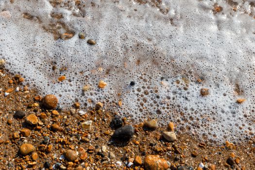 Waves lapping the pebbles on Brighton beach, England, United Kingdom