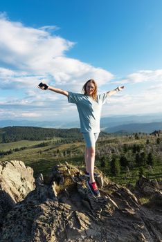 Domestic tourism, travel, lesure and freedom concept after pandemic- woman on the top of Altai mountain, beauty summer evening landcape