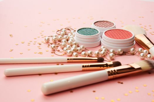 eyeshadow makeup brushes collection professional cosmetics accessories on pink background. High quality photo