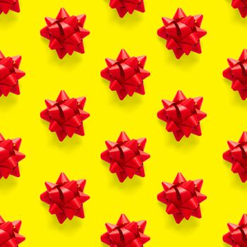 Seamless regular creative Christmas pattern with New Year decorations on yellow background. xmas Modern Seamless pattern made from christmas decorations. Photo quality pattern for fabric, prints, wallpapers, banners or creative design works.