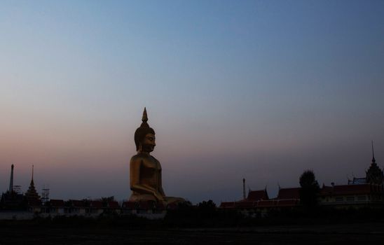 Buddha with black of silhouette at the sunset.