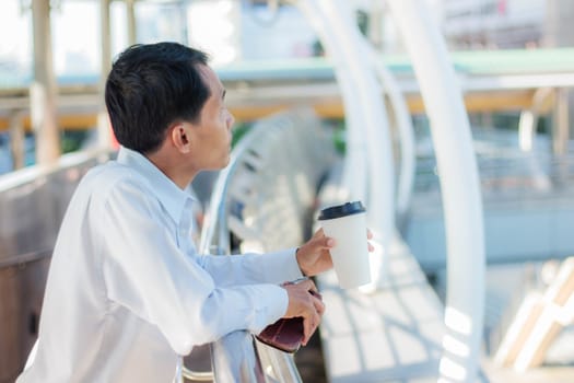 Man holding cup of coffee during a break.