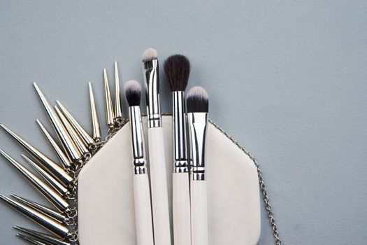 professional makeup brushes on stand on gray background and copy space cropped view. High quality photo