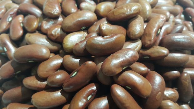 Kidenry beans:   Closeup view of uncooked red kidney beans. Dark red useful beans background.