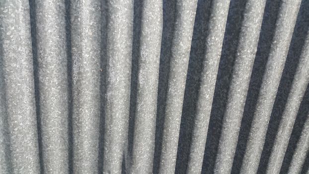 Silver corrugated metal sheet texture background. Steel metal cinc galvanized wave metal sheet for roof and walls.