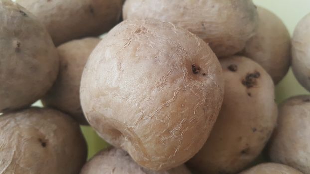  close up view of fresh organic potato in market:  Food background texture of raw potatoes