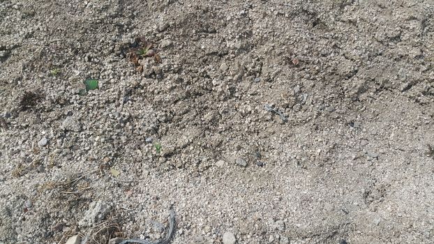 Close view of natural background of a field for farming. Dry agricultural brown soil detailed. 