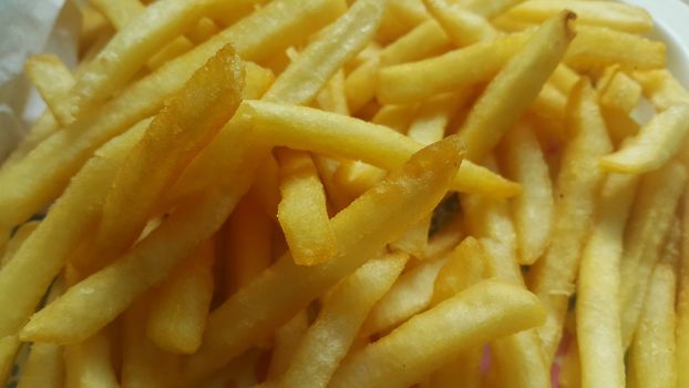 Closeup view of potato french fries or roasted slices with copy space for text