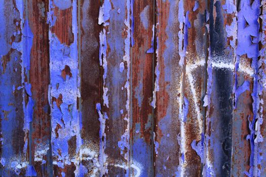 Colorful texture of old paint on rusty metal door