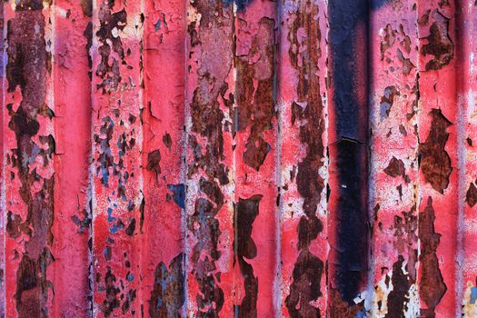 Colorful texture of old paint on rusty metal door