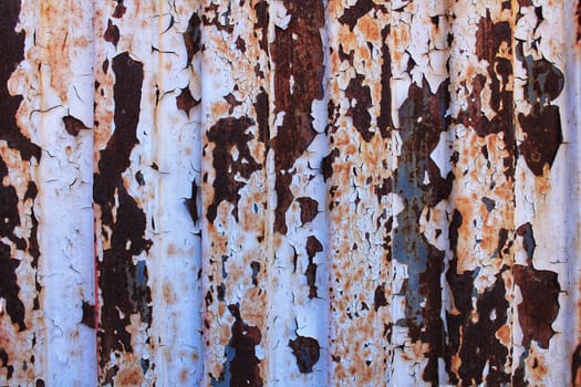 Colorful texture of old paint on rusty metal door