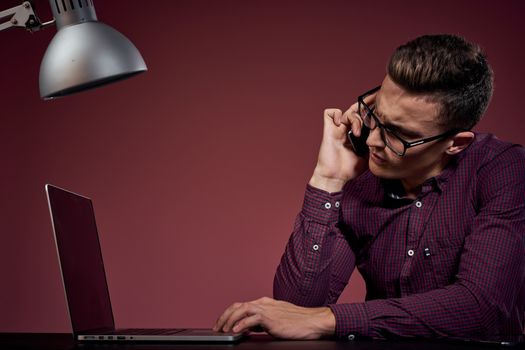 Business man in office and talking on the phone manager red background model cropped view of laptop tablet. High quality photo