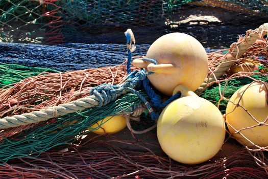 Fishing nets background and colorful buoys in the port of Santa Pola, Alicante
