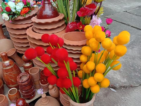 red and yellow cotton flower with pot