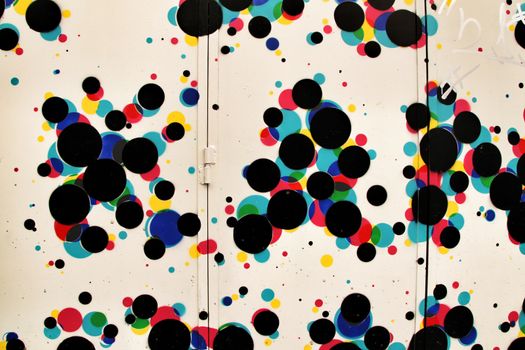 Colorful circles painted on a metal door