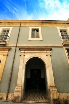 Old facade of a majestic building in Santa Cruz neighborhood in Alicante, Spain