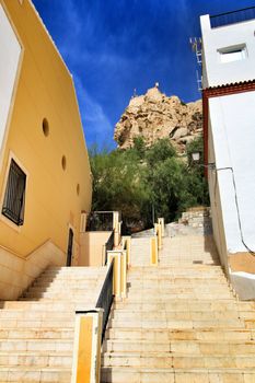 Narrow streets with old facades, windows and balconies of Santa Cruz  neighborghood in Alicante city