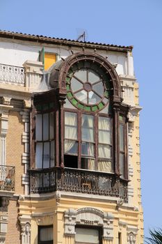 Old colorful and beautiful facade with wooden window in Cartagena street in Summer.