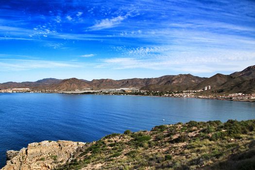 Beautiful beach with boats , cliffs and mountains in La Azohia village in Cartagena, Murcia, Spain in a sunny day. Views from Santa Elena tower viewpoint.