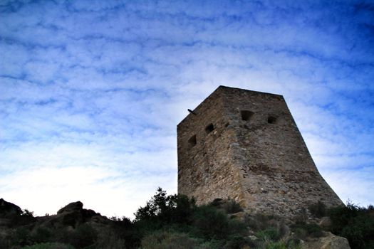 Strong stone vigilance tower in the mountain of Carricola village in Valencia, Spain.