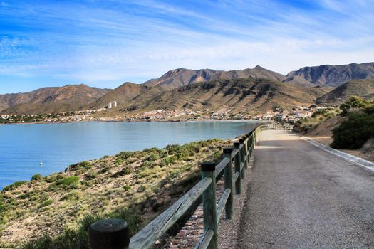 Beautiful beach with boats , cliffs and mountains in La Azohia village in Cartagena, Murcia, Spain in a sunny day. Views from Santa Elena tower viewpoint.