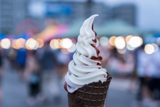 Hand holding ice cream cone.