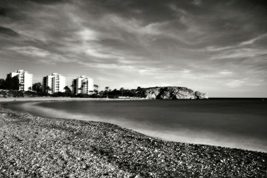 Beautiful Mojon beach in Isla Plana, Cartagena, Murcia, Spain. Buildings in the background.