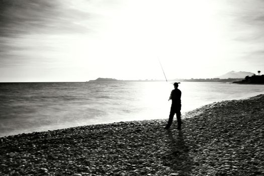 Fisherman in the evening on Mojon beach in Isla Plana, Cartagena, Murcia,Spain.