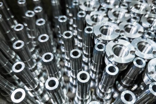 Shiny steel parts close-up background, long clean steel rods after fine cnc turning.