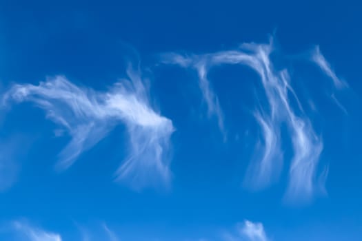 Stunning cirrus cloud formation panorama in a deep blue summer sky seen over Europe