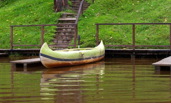 One boat on a lake is parked on a jetty