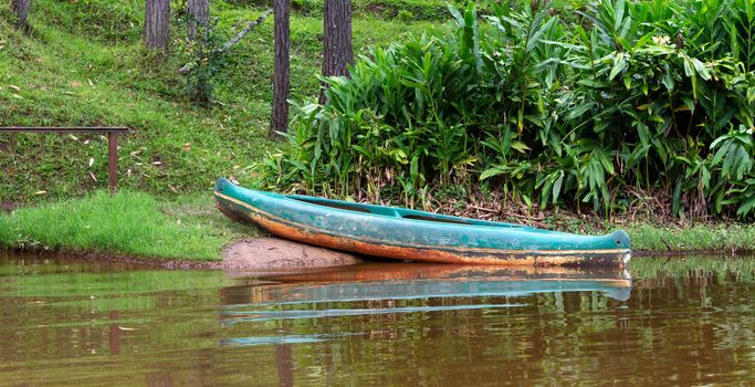 One boat on a lake is parked on a jetty