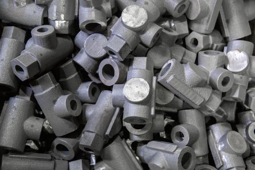 abstract industrial full frame close-up background of gray steel castings storage pile