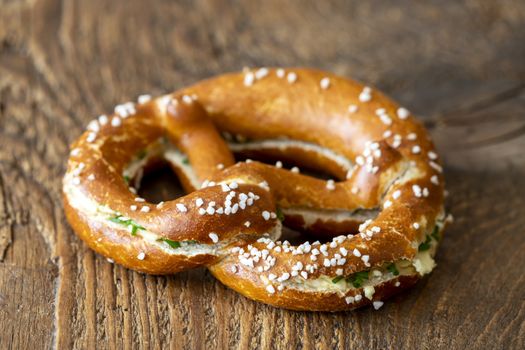 bavarian pretzel with butter on wood