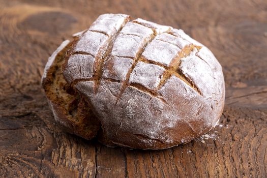 fresh rye bread on dark wood